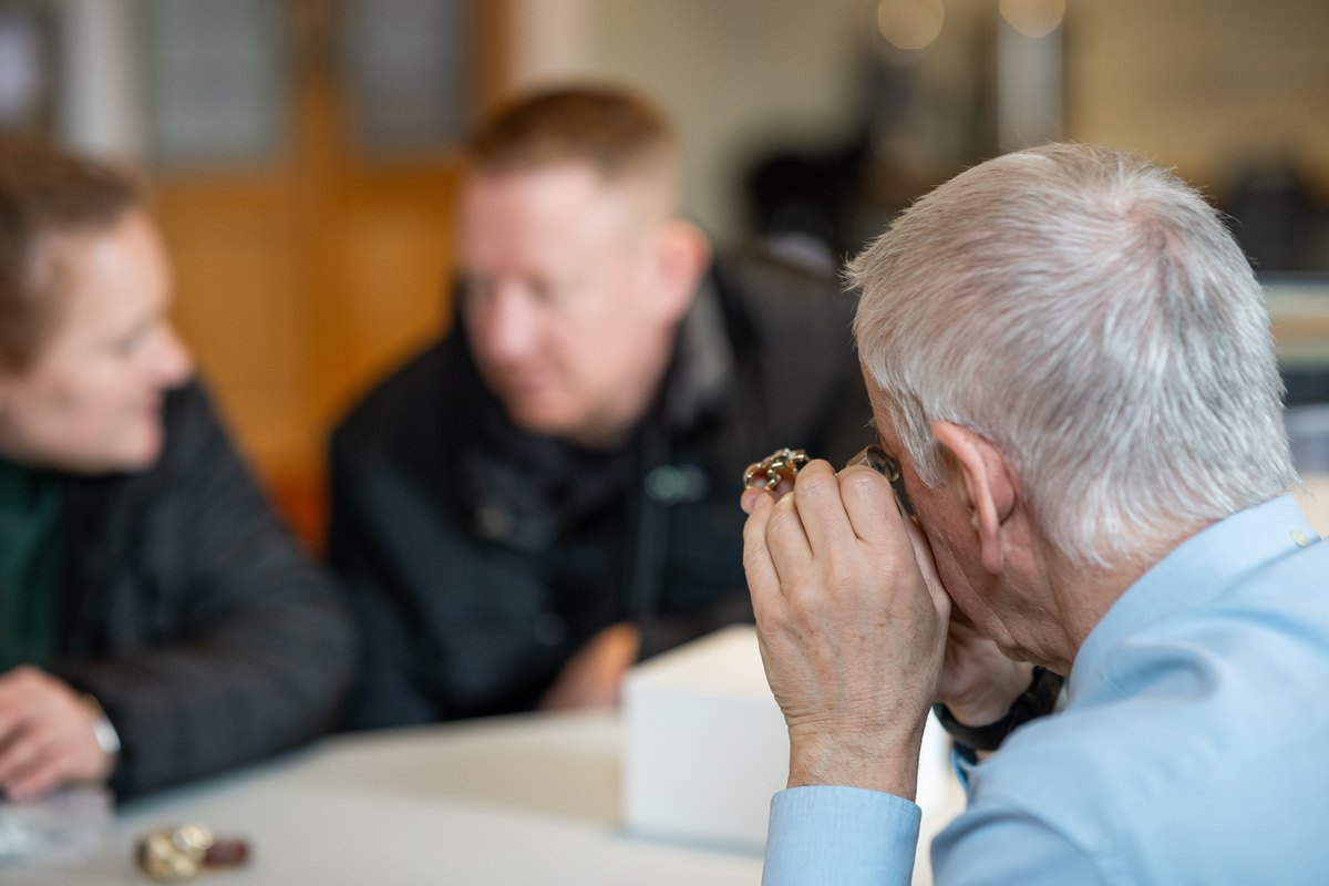 Auctioneum valuers examining items with a client