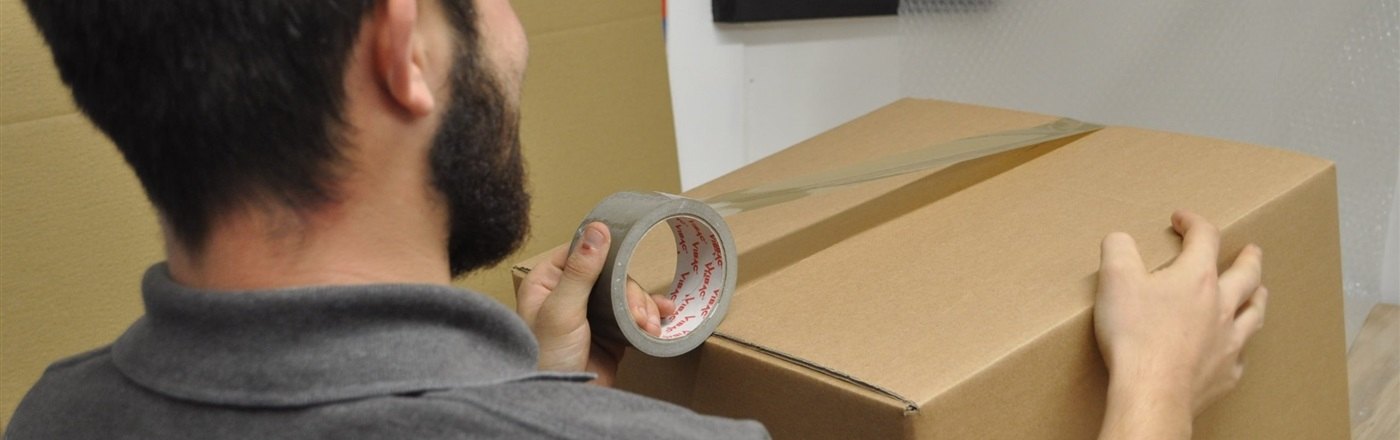 A parcel being packed by the Auctioneum dispatch team